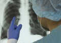 A doctor examines an X-ray of a patient s lung infected with covid-19 coronavirus Royalty Free Stock Photo