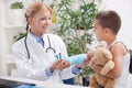 Doctor examines, young boy wearing a blue cast Royalty Free Stock Photo