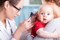 Doctor examining baby boy with otoscope Royalty Free Stock Photo