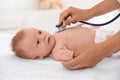 Doctor examining baby with stethoscope indoors, closeup. Health care Royalty Free Stock Photo