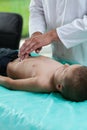 Doctor examining boy stomach