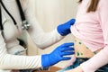 Doctor examining a child covered with green rashes on stomach ill with chickenpox, measles or rubella virus Royalty Free Stock Photo