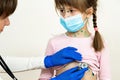 Doctor examining child girl covered with green rashes on face and stomach ill with chickenpox, measles or rubella virus Royalty Free Stock Photo