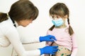 Doctor examining child girl covered with green rashes on face and stomach ill with chickenpox, measles or rubella virus Royalty Free Stock Photo