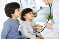 Doctor examining a child patient by stethoscope. Cute arab boy at physician appointment. Medicine and healthcare concept Royalty Free Stock Photo