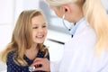 Doctor examining a child patient by stethoscope. Cute baby girl at physician appointment. Medicine concept Royalty Free Stock Photo