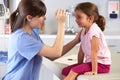 Doctor Examining Child's Eyes In Doctor's Office