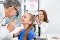 Doctor examining eyes of patient with eye test device. Royalty Free Stock Photo