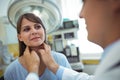 Doctor examining a female patients neck Royalty Free Stock Photo