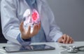 Doctor examining heart with hologram in hand. The concept of using modern technology to help diagnose, treat, and maintain heart Royalty Free Stock Photo