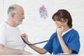 Doctor examining heartbeat of senior Man Royalty Free Stock Photo