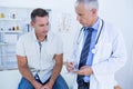 Doctor examining his patient and writing on clipboard Royalty Free Stock Photo