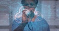 Doctor examining holographic cloud interface using stethoscope in tech clinic, with data streams Royalty Free Stock Photo