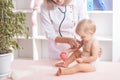 Doctor examining little baby with stethoscope in clinic. Baby health concept Royalty Free Stock Photo