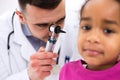 Doctor examining little girl patient's ear Royalty Free Stock Photo