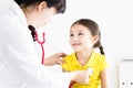 Doctor examining little girl by stethoscope Royalty Free Stock Photo