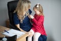 Doctor examining a little girl by stethoscope Royalty Free Stock Photo