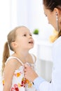 Doctor examining a little girl by stethoscope. Happy smiling child patient at usual medical inspection. Medicine and Royalty Free Stock Photo