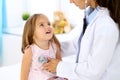 Doctor examining a little girl by stethoscope