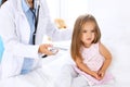 Doctor examining a little girl by stethoscope. Patient turned away from his physician Royalty Free Stock Photo