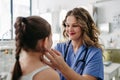 Doctor examining lymp nodes on neck of the young girl. Palpation of lymph nodes. Concept of preventive health care for