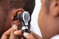 Doctor Examining Male Patient`s Ear