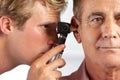 Doctor Examining Male Patient's Ears Royalty Free Stock Photo
