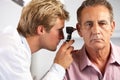 Doctor Examining Male Patient's Ears Royalty Free Stock Photo