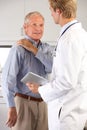 Doctor Examining Male Patient With Shoulder Pain Royalty Free Stock Photo