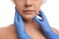 Doctor examining mature woman on background, closeup. Double chin surgery Royalty Free Stock Photo