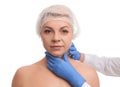 Doctor examining mature woman on background. Double chin surgery Royalty Free Stock Photo