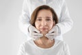 Doctor examining mature woman face before cosmetic surgery Royalty Free Stock Photo