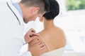 Doctor examining mole on back of woman