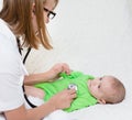 Doctor examining newborn baby with stethoscope Royalty Free Stock Photo