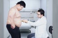 Doctor examining a patient obesity Royalty Free Stock Photo