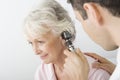 Doctor Examining Patient's Ear Using Otoscope