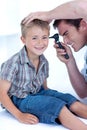 Doctor examining a patient' s ears Royalty Free Stock Photo