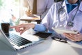 Doctor examining patient`s medical records and medical team working. Royalty Free Stock Photo