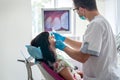 Doctor examining patient`s teeth with intraoral camera Royalty Free Stock Photo
