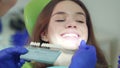 Doctor examining patient teeth whiteness. Close up dentist selecting color