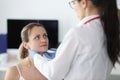Doctor examining patients submandibular lymph nodes in clinic