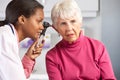 Doctor Examining Senior Female Patient's Ears Royalty Free Stock Photo