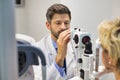 Closeup of doctor examining senior womans eye at hospital Royalty Free Stock Photo