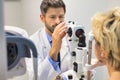 Closeup of doctor examining senior womans eye at hospital Royalty Free Stock Photo