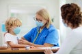 Doctor examining sick child in face mask Royalty Free Stock Photo