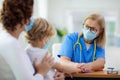 Doctor examining sick child in face mask Royalty Free Stock Photo