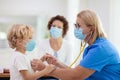 Doctor examining sick child in face mask Royalty Free Stock Photo