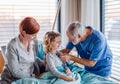 Doctor examining a small hospitalized girl with mother in hospital. Royalty Free Stock Photo