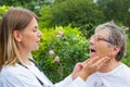 Doctor examining sore throat Royalty Free Stock Photo