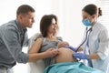 Doctor examining woman before giving child birth in maternity hospital Royalty Free Stock Photo